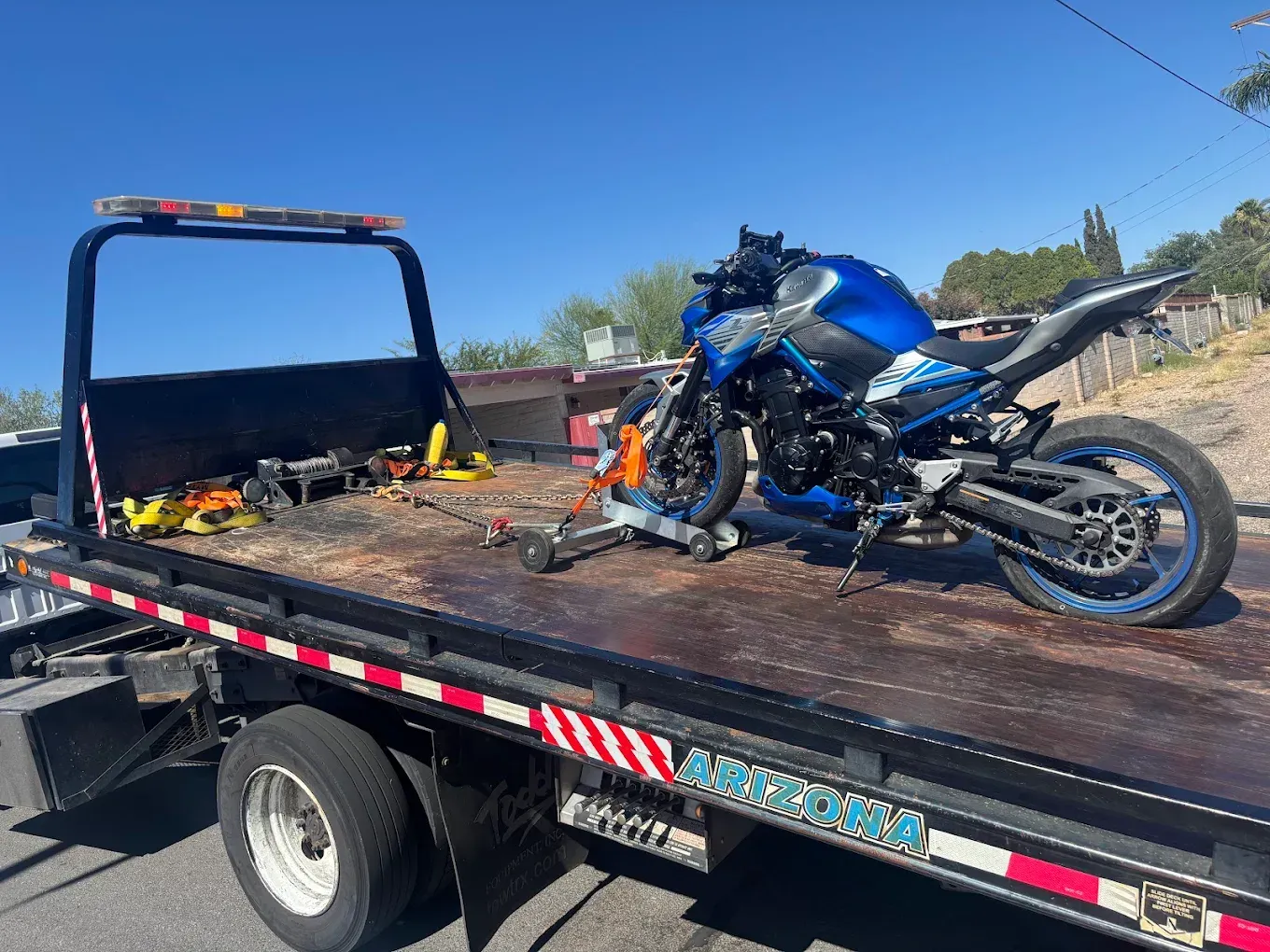 Motorcycle secured on a Sam's Towing flatbed after a Tucson recovery